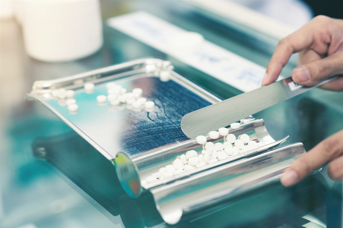 Medicine being measured on a pharmacy dispensing tray