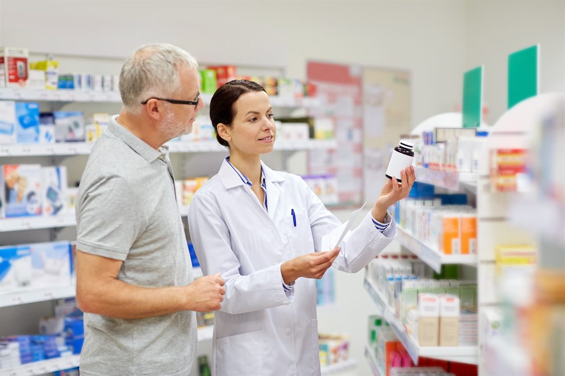 Pharmacist advising a patient at the pharmacy counter